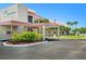 Welcoming clubhouse entrance with covered drop-off and lush landscaping at 2960 59Th S St # 411, Gulfport, FL 33707