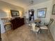 Bright dining area with glass table and four chairs, adjacent to kitchen at 2960 59Th S St # 411, Gulfport, FL 33707