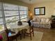 Bright dining area with table, chairs, and window views at 2960 59Th S St # 411, Gulfport, FL 33707