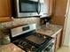 Gas cooktop and microwave in updated kitchen at 2960 59Th S St # 411, Gulfport, FL 33707