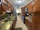 Modern kitchen with stainless steel appliances and wood cabinets at 2960 59Th S St # 411, Gulfport, FL 33707