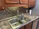 Double stainless steel sink with granite countertop in kitchen at 2960 59Th S St # 411, Gulfport, FL 33707