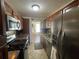 Modern kitchen with stainless steel appliances and wood cabinets at 2960 59Th S St # 411, Gulfport, FL 33707