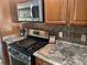 Stainless steel gas cooktop and microwave in updated kitchen at 2960 59Th S St # 411, Gulfport, FL 33707