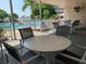 Outdoor seating area near the pool, offering a relaxing space to enjoy the poolside view at 2960 59Th S St # 411, Gulfport, FL 33707