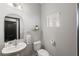 Clean and modern bathroom with white pedestal sink and toilet at 3106 W Hartnett Ave, Tampa, FL 33611