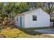 Detached garage with blue door and window at 3508 N Dartmouth Ave, Tampa, FL 33603