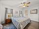 Main bedroom with king bed, ceiling fan, and wood flooring at 37701 Rio Ln, Zephyrhills, FL 33541