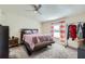 Main bedroom with a plush bed, ceiling fan, and ample closet space at 40251 Laird Ave, Zephyrhills, FL 33540