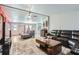 Open-concept living room with leather seating, looking toward the kitchen at 40251 Laird Ave, Zephyrhills, FL 33540