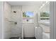 Sleek bathroom featuring a tile shower with glass shelves and modern fixtures at 4145 Harrisburg Ne St, St Petersburg, FL 33703