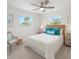 Bright bedroom featuring neutral walls, ceiling fan, and natural light from two windows at 4145 Harrisburg Ne St, St Petersburg, FL 33703
