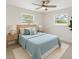 Bedroom with neutral walls, ceiling fan, and natural light from two windows at 4145 Harrisburg Ne St, St Petersburg, FL 33703