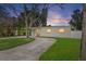 Charming single-story home featuring a well-manicured lawn and a long driveway at 4145 Harrisburg Ne St, St Petersburg, FL 33703