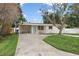 Charming single-story home featuring a well-manicured lawn and a long driveway at 4145 Harrisburg Ne St, St Petersburg, FL 33703