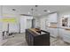 Bright kitchen featuring new cabinets and modern grey wood-style floors at 4145 Harrisburg Ne St, St Petersburg, FL 33703