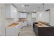 Bright kitchen featuring new cabinets and modern grey wood-style floors at 4145 Harrisburg Ne St, St Petersburg, FL 33703