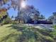 Large backyard with a grassy area and storage shed at 4510 W Mcelroy Ave, Tampa, FL 33611