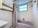 Lavender bathtub and shower with a gray shower curtain at 4510 W Mcelroy Ave, Tampa, FL 33611