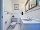 Bathroom with lavender toilet and vanity, white tiled walls, and mirrors at 4510 W Mcelroy Ave, Tampa, FL 33611