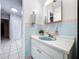 Bathroom with light blue tile and a vanity at 4510 W Mcelroy Ave, Tampa, FL 33611