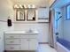 Lavender bathroom with shower/tub combo, vanity, and tiled floors at 4510 W Mcelroy Ave, Tampa, FL 33611
