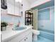 Clean bathroom with light blue tile and white vanity at 4510 W Mcelroy Ave, Tampa, FL 33611