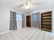 Bedroom with tile floor, window coverings, and built-in shelves at 4510 W Mcelroy Ave, Tampa, FL 33611