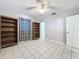 Spacious bedroom with built-in bookshelves and tiled floors at 4510 W Mcelroy Ave, Tampa, FL 33611