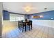 A dining area with a table and chairs, a ceiling fan, and blue walls at 4510 W Mcelroy Ave, Tampa, FL 33611