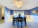 Bright dining area with a wood table, six chairs, and a ceiling fan at 4510 W Mcelroy Ave, Tampa, FL 33611