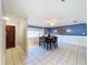 Dining room with a blue accent wall, tile floors, and a table with chairs at 4510 W Mcelroy Ave, Tampa, FL 33611