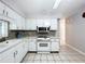 Bright kitchen with white cabinets and mosaic backsplash at 4510 W Mcelroy Ave, Tampa, FL 33611