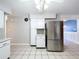 Kitchen boasts stainless steel refrigerator and white cabinets at 4510 W Mcelroy Ave, Tampa, FL 33611
