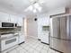 Updated kitchen featuring stainless steel refrigerator and white cabinetry at 4510 W Mcelroy Ave, Tampa, FL 33611