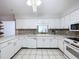 Modern kitchen with white cabinets and a mosaic backsplash at 4510 W Mcelroy Ave, Tampa, FL 33611
