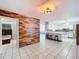 Kitchen with island, stainless steel appliances, and view into adjacent room at 4510 W Mcelroy Ave, Tampa, FL 33611