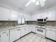 Bright kitchen with white cabinets, mosaic backsplash, and stainless steel appliances at 4510 W Mcelroy Ave, Tampa, FL 33611
