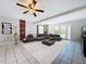 Bright living room with sectional sofa, wood accent wall, and access to backyard at 4510 W Mcelroy Ave, Tampa, FL 33611