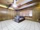 Living room with wood paneling, fireplace, and tiled floors at 4510 W Mcelroy Ave, Tampa, FL 33611
