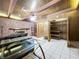 Living room with stone fireplace and wood paneling at 4510 W Mcelroy Ave, Tampa, FL 33611