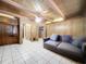 Living room with wood paneling, tiled floors, and built-in shelving at 4510 W Mcelroy Ave, Tampa, FL 33611
