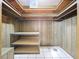 Storage room with shelving unit and wood paneling at 4510 W Mcelroy Ave, Tampa, FL 33611