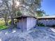 Wooden storage shed in the backyard with a covered area at 4510 W Mcelroy Ave, Tampa, FL 33611