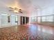 Sunroom with terracotta tile floor, built-in shelves, and large windows at 4510 W Mcelroy Ave, Tampa, FL 33611