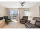 Living room with sliding doors to balcony and comfortable seating at 4900 38Th S Way # 305, St Petersburg, FL 33711