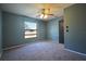 Bright bedroom featuring a large window and ceiling fan at 5224 Courtland Rd, Spring Hill, FL 34608