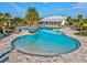 Freeform pool with a shallow end and lounge area at 5344 Little Stream Ln, Wesley Chapel, FL 33545