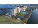 Scenic aerial showing waterfront condos featuring tennis courts and docks, complemented by lush landscaping at 5915 Sea Ranch Dr # 408, Hudson, FL 34667