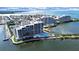 Aerial view showcasing condos with scenic water views, and a refreshing pool at 5915 Sea Ranch Dr # 408, Hudson, FL 34667